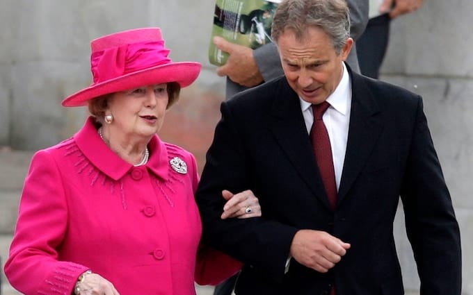 Tony Blair walking, literally arm-in-arm, with Margaret Thatcher.